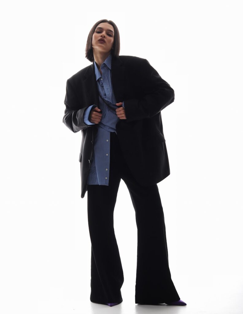 a woman in a women's trouser suit is posing for a picture